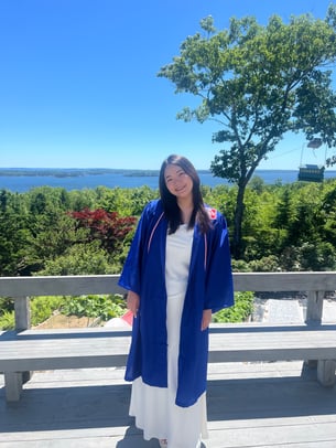 Mimi_wearing a graduation robe and dress in Maine